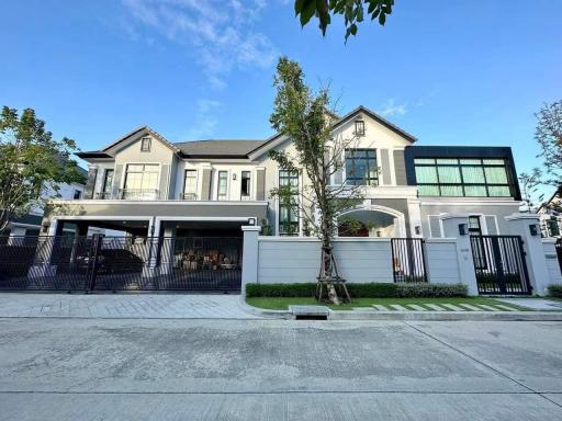 Elegant two-story house with spacious garage and landscaped front yard