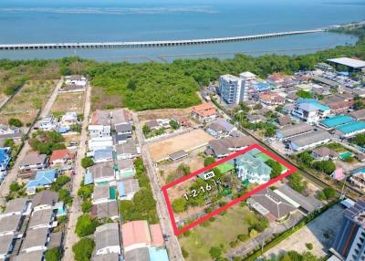 Aerial view of a property with marked boundaries near coastal area