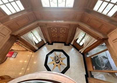 Elevated interior view of a building with detailed ceiling work and a decorative floor design