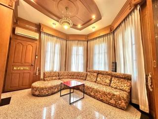 Elegant living room with patterned sofa set and chandelier