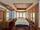 Spacious bedroom with wooden furnishing and ample lighting