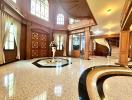 Luxurious grand entrance of a building with marble floors and elegant wood paneling