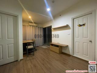 Spacious bedroom with wooden flooring, modern lighting, and built-in shelf