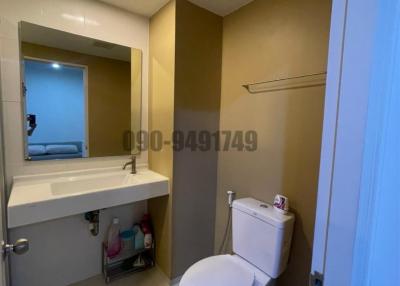 Modern bathroom interior with clean white fixtures and beige wall