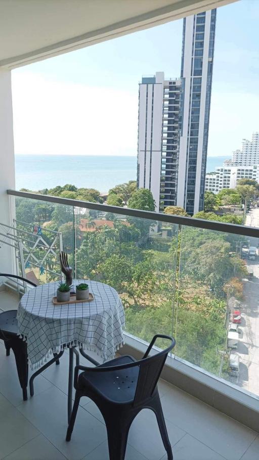 Spacious balcony with outdoor seating and scenic view of the city