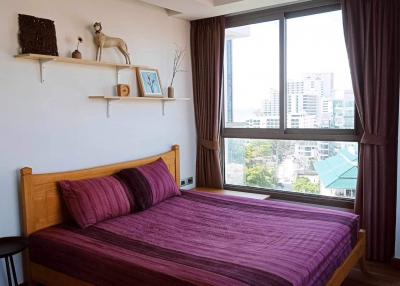 Cozy bedroom with a large window and modern decor