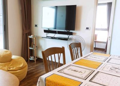 Bright living room with modern furniture and wall-mounted television