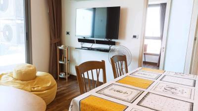 Bright living room with modern furniture and wall-mounted television