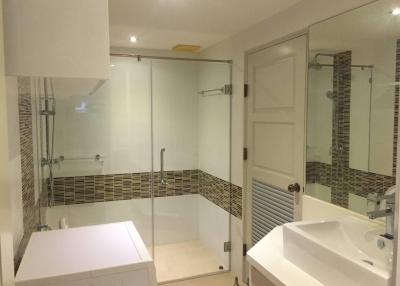 Modern bathroom with glass shower enclosure and vanity