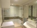 Modern bathroom with glass shower enclosure and vanity