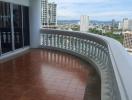 Spacious balcony with city view and terracotta floor tiles