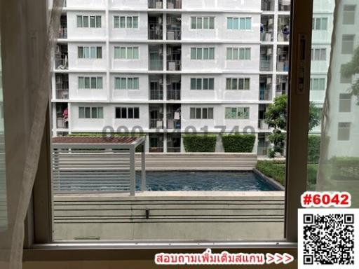 Apartment window view overlooking the swimming pool and neighboring building