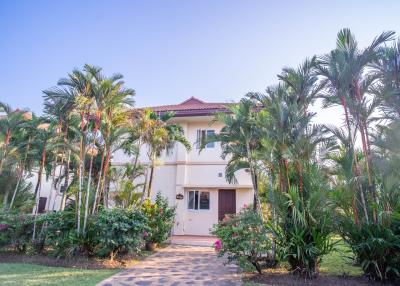 Exterior view of a tropical house with palm trees