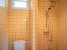 Bright bathroom with yellow tiles, shower and toilet