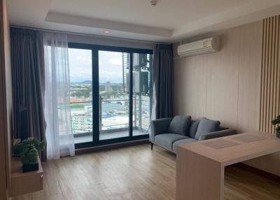 Spacious living room with large windows and city view