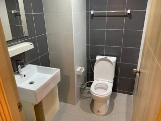 Modern bathroom with gray tiles and white fixtures