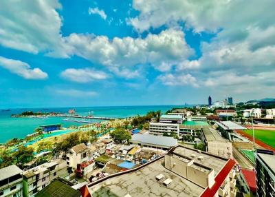 Panoramic aerial view of a coastal area showing buildings, beach, and ocean