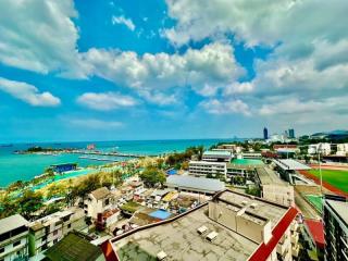 Panoramic aerial view of a coastal area showing buildings, beach, and ocean