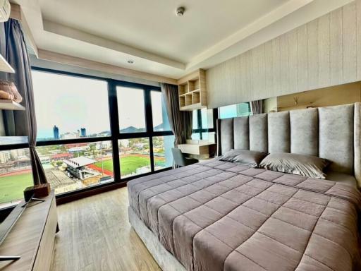 Modern bedroom with large window and city view