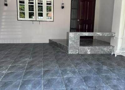 Modern home entryway with marble steps and tiled flooring