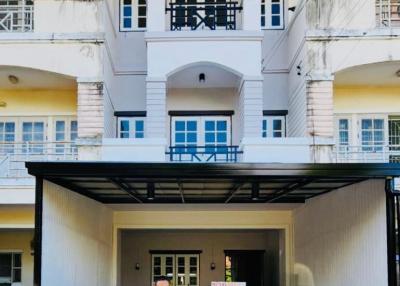 Modern two-story building with balcony and covered parking space