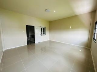 Spacious empty living area with glossy tiled flooring