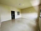 Spacious empty living area with glossy tiled flooring
