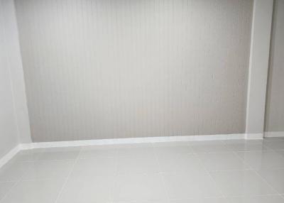 Empty white room with tiled flooring and recessed lighting