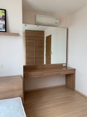 Bright and cozy bedroom with wooden furniture and air conditioning