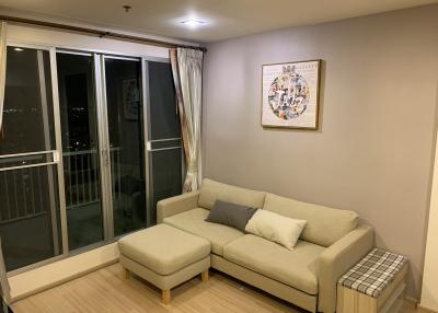 Cozy living room at night with comfortable seating and balcony access