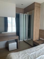 Modern bedroom with large wardrobe and wooden finish