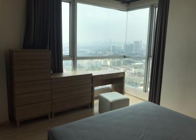 Spacious bedroom with large window offering city views