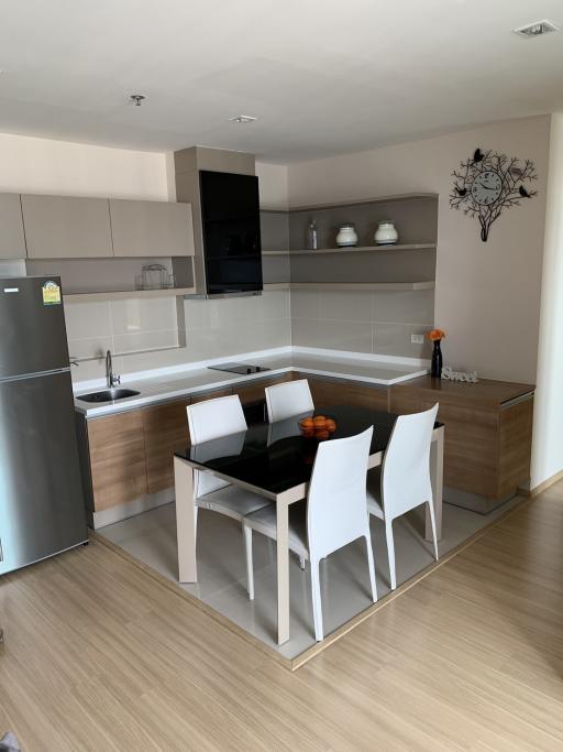 Modern kitchen with dining area and integrated appliances