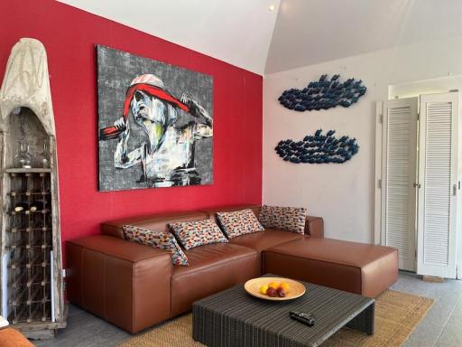 Modern living room with red accent wall and contemporary art
