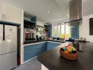 Modern kitchen with blue cabinets and stainless steel appliances
