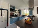 Modern kitchen with blue cabinets and stainless steel appliances
