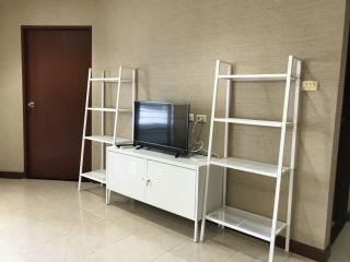 Compact living room with TV and shelving units