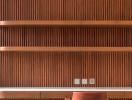Stylish living room with wooden slat walls and minimalist shelving