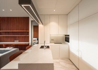 Modern kitchen with integrated appliances and marble flooring