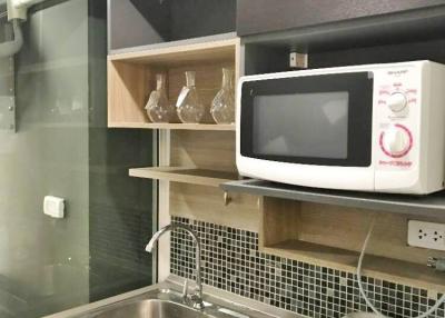 Compact modern kitchen with microwave and sink