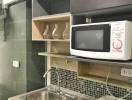 Compact modern kitchen with microwave and sink