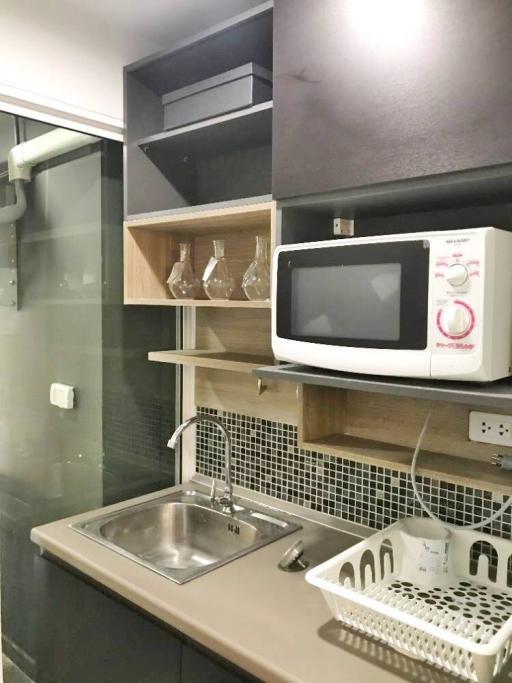 Compact modern kitchen with microwave and sink