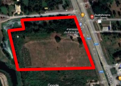 Aerial view of a vacant land plot outlined in red for property listing