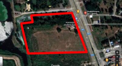 Aerial view of a vacant land plot outlined in red for property listing