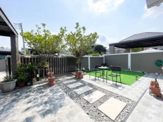 Spacious outdoor patio with seating area and greenery