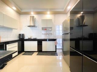 Modern kitchen with white tiles and stainless steel appliances