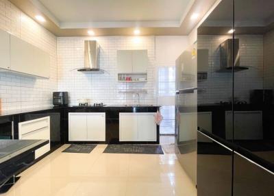 Modern kitchen with white tiles and stainless steel appliances