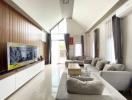 Spacious and modern living room with large windows and elegant furnishings