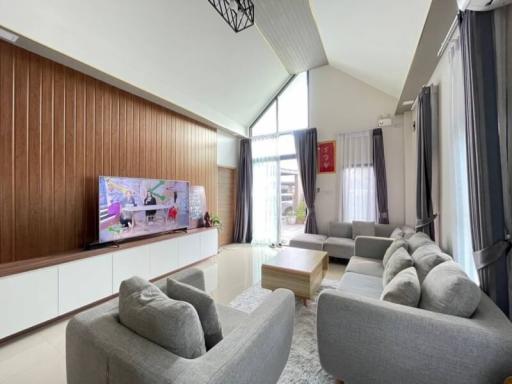 Spacious and modern living room with high ceiling and natural light