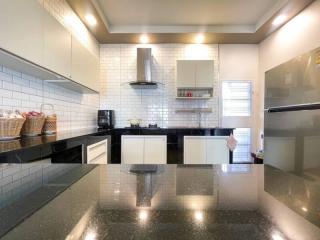 Modern kitchen with stainless steel appliances and black countertops